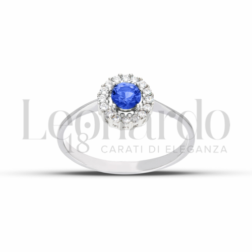 Contornato da una fila di zirconi Modello con Pietra di Colore Blu e zirconi bianchi in Oro Bianco da 2,1gr.