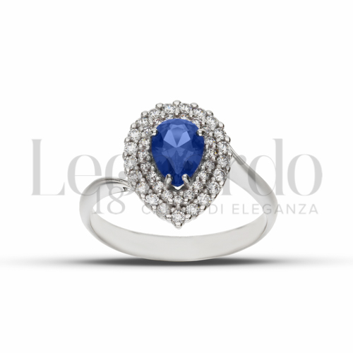 Contornato da due file di zirconi Modello con Pietra di Colore Blu e zirconi bianchi in Oro Bianco da 3,8gr.