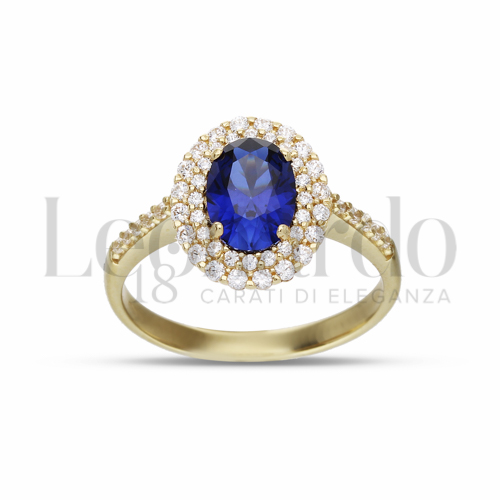 Contornato da due file di zirconi Modello con Pietra di Colore Blu e zirconi bianchi in Oro Giallo da 3,8gr.