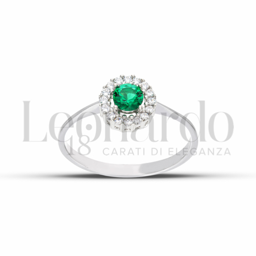 Contornato da una fila di zirconi Modello con Pietra di Colore Verde e zirconi bianchi in Oro Bianco da 2,2gr.