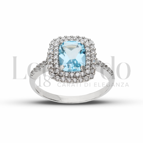 Contornato da due file di zirconi Modello con Topazio azzurro e zirconi bianchi in Oro Bianco da 4gr.