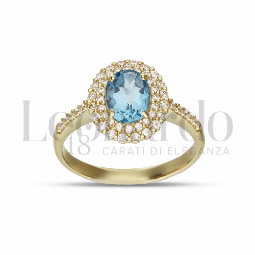 Contornato da due file di zirconi Modello con Topazio azzurro e zirconi bianchi in Oro Giallo da 3,8gr.
